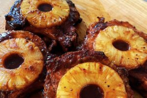 Cooking Smoked Pork Chops with Pineapple on Stove